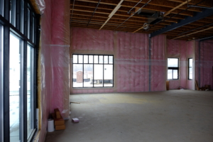 new commercial construction with pink insulation and vapor barrier